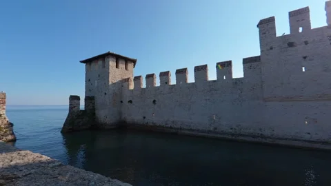 Stabilized lateral move of medieval brick castle walls extending into lake Stock Footage 322099862