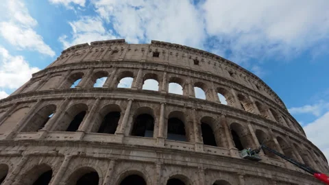 Stabilized low walk of Colosseum main facade on clear day with clouds Stock Footage 322109914