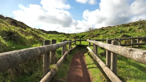 Stabilized POV Shot Walking Through A Green Field Walkway, Azores Stock Footage 89245929
