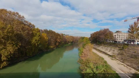 Stabilized right-to-left walk from bridge over river with autumn trees and city Stock Footage 322115662