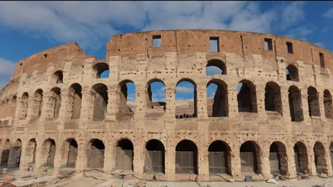 Stabilized right-to-left walk past rear Colosseum facade with workers and touris Stock Footage 322117636