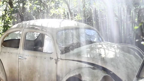 A stabilized shot from light rays through smoke shining over a old beetle waste  Vídeos de archivo 194396375