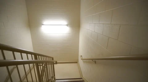 Stabilized shot quickly moving down stairs in stairwell Video stock 59563550