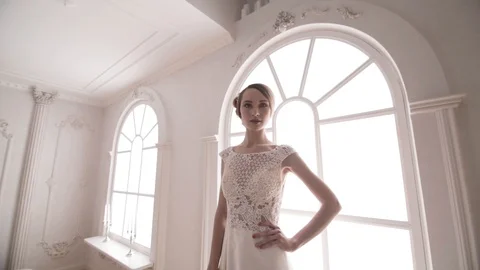 Stabilized shot of young bride standing near window. Morning bride Video stock 104576722