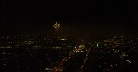 Stable aerial zoom in on fireworks exploding over city, night Stock Footage 102199824