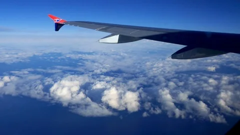 Stable POV passenger view looking at clouds from above sky in an airplane Stock Footage 92642006
