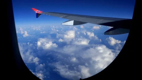 Stable POV passenger view looking at clouds from above sky in an airplane Stock Footage 92642200
