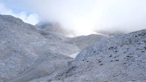 Stable shot Triglav summit covered with fogs/ clouds and trail to summit Stock Footage 161908224