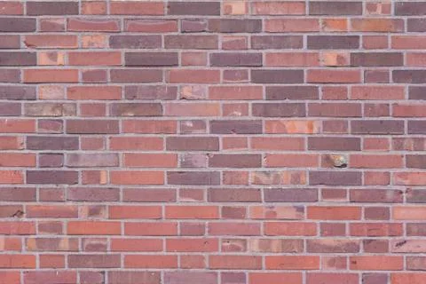 Stable stone wall with rows of crafted masonry factory stones. Brickwork with Stock Photos