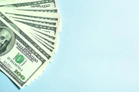 A stack of $ 100 bills on a cyan background, hundred dollars. Concept Busines 스톡 사진
