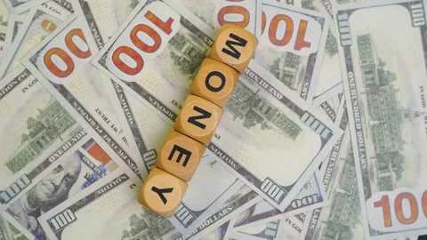 A stack of 100 dollar bills is arranged on a turntable and on top of it the.. Stock Footage 308878176
