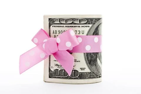 Stack of 100-dollar bills a stack of 100-dollar bills with a holiday bow i... Foto stock