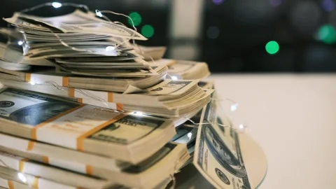 Stack of 100 dollars banknotes rotating on white table, close up. Stock Footage 249050645