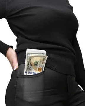 A stack of 100 dollars bills sticking out of the front pocket of women's jean Stock Photos
