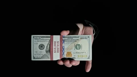 Stack of 10000 American Dollars in Bundle in Male Hands on Black Background Stock Footage 169464764