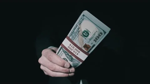 Stack of 10000 American Dollars in Bundle in Male Hands on Black Background Stock Footage 169465143