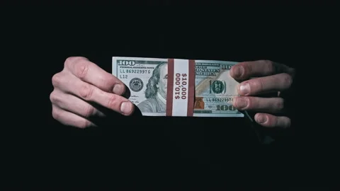 Stack of 10000 American Dollars in Bundle in Male Hands on Black Background Stock Footage 169465626