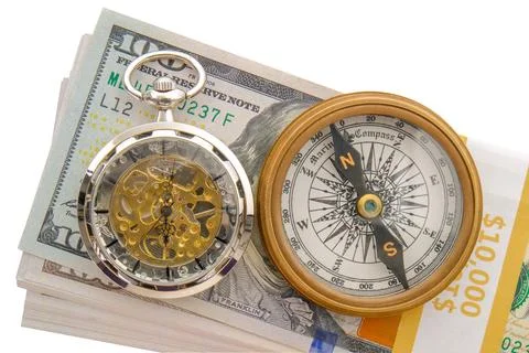 Stack of 10.000 in hundred dollar bills with a compass, modern pocket watch 写真素材