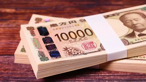 Stack of 10,000 yen bills on wooden table, rotating Stock Footage 304254036