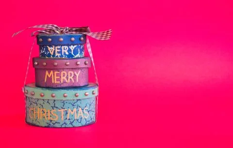 Stack of 3 Christmas gift boxes isolated on a red background Stock Photos