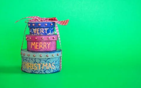 Stack of 3 Christmas gift boxes isolated on a green background Stock Photos