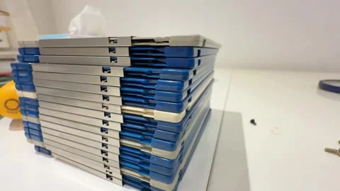 Stack of 3,5" computer floppy disks on desk Stock Footage 299719944