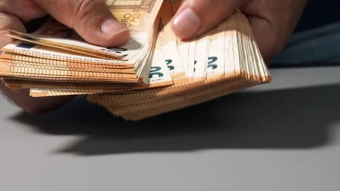 A stack of 50 euro banknotes in hands, the concept of savings banks, banking, pa Stock Footage 247339379