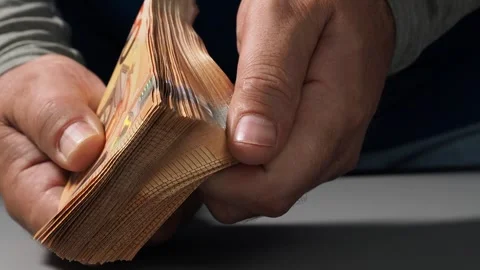 A stack of 50 euro banknotes in hands, the concept of savings banks, banking, pa Stock Footage 247570403