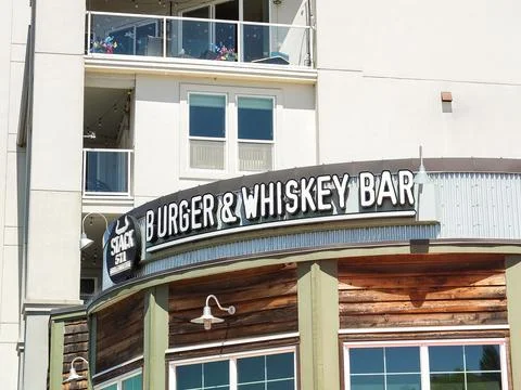 Stack 571 Burger and Whiskey Bar curved modern restaurant sign on a wooden .. Фото