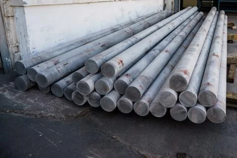 Stack of aluminium billets. Heap of aluminium bar in aluminum profiles factory Stock Photos
