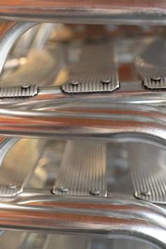 Stack of aluminium chairs in a restaurant. Stock Photos