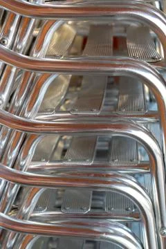 Stack of aluminium chairs in a restaurant. Stock Photos