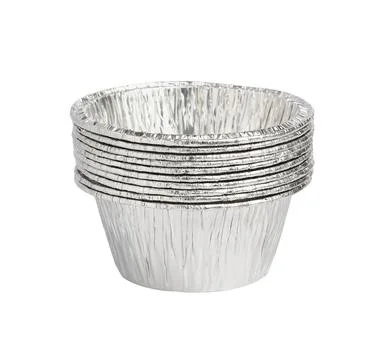 Stack of aluminum baking molds isolated on white background close-up Stock Photos
