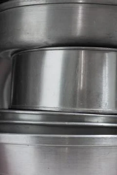 Stack of aluminum kitchen utensils close up Stock Photos