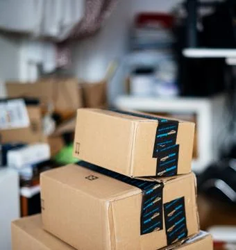 Stack of Amazon Prime cardboard boxes one above another Stock Photos