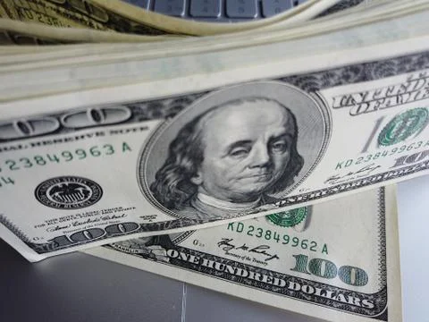 Stack of american dollars on laptop keyboard background. A lot of american do Foto stock