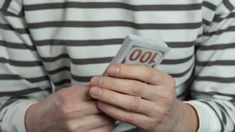 A stack of American dollars in a man's hands close-up. Stock Footage 306945090