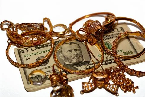 A stack of American dollars money banknotes with a set of gold accessories Foto stock