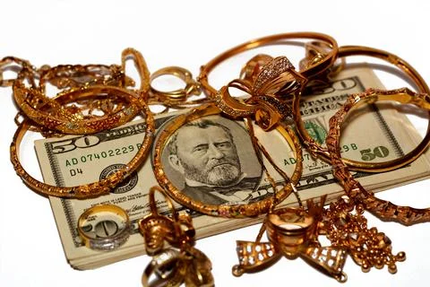 A stack of American dollars money banknotes with a set of gold accessories Foto stock