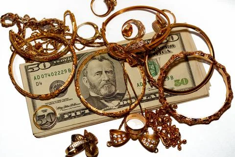 A stack of American dollars money banknotes with a set of gold accessories 스톡 사진