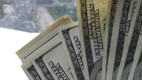 Stack of american dollars on urban background. A lot of American dollars on t Stock Footage 111160761