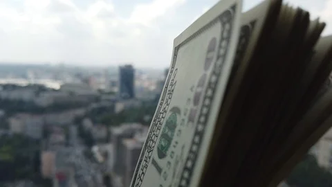 Stack of american dollars on urban background. A lot of American dollars on t Stock Footage 111161590