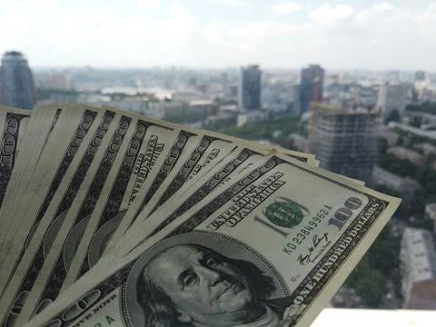 Stack of american dollars on urban background. A lot of American dollars on t Stock Photos