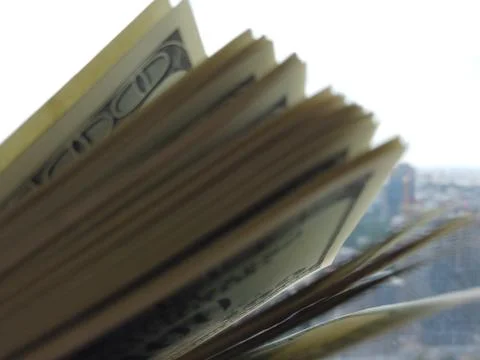Stack of american dollars on urban background. A lot of American dollars on t Stock Photos