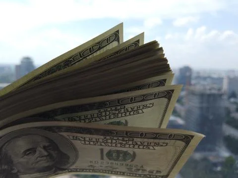 Stack of american dollars on urban background. A lot of American dollars on t 스톡 사진