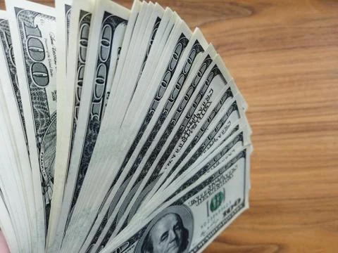 Stack of american dollars on wooden background. A lot of American dollars. Foto stock