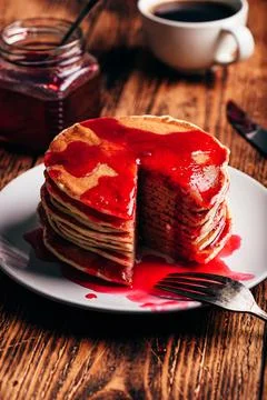 Stack of american pancakes with red berry jam Stock Photos