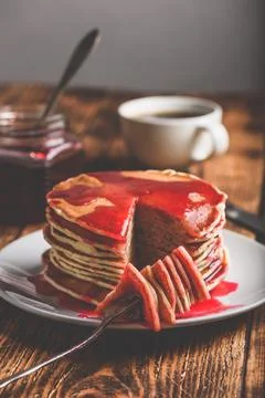 Stack of american pancakes with red berry jam Stock Photos