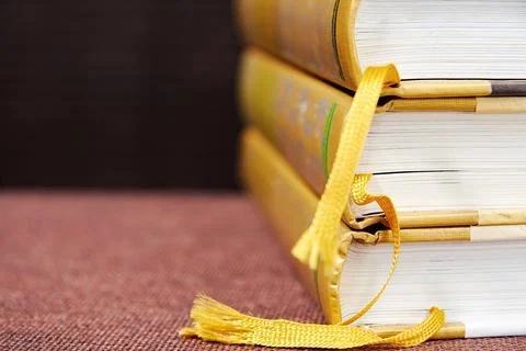 Stack of ancient leather hardcovered books on the bookshelf in the library 写真素材