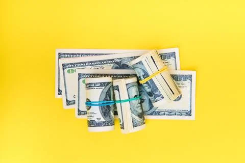 Stack and rolls of hundred dollar bills Stock Photos